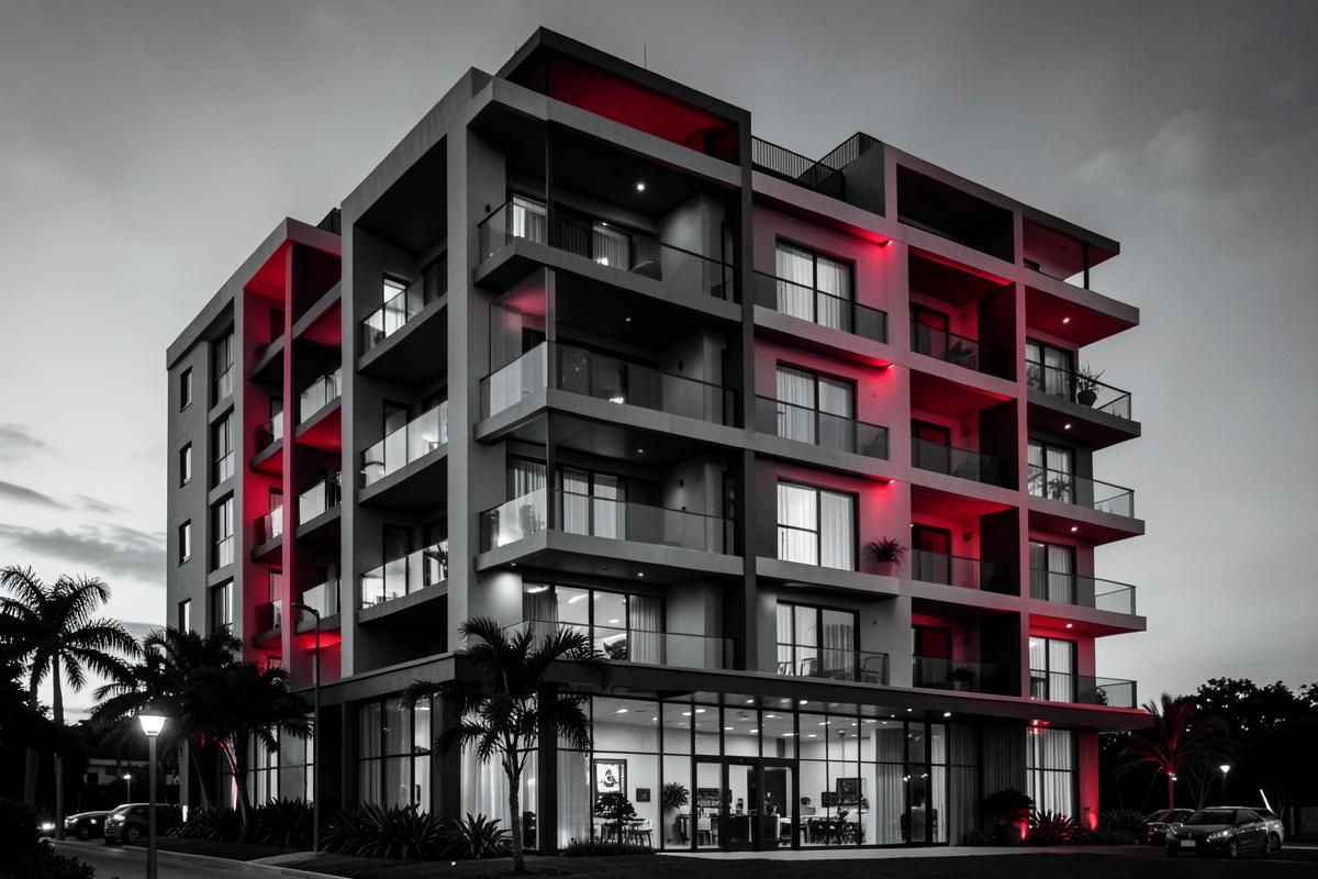 Edifício residencial de alto padrão iluminado ao anoitecer
