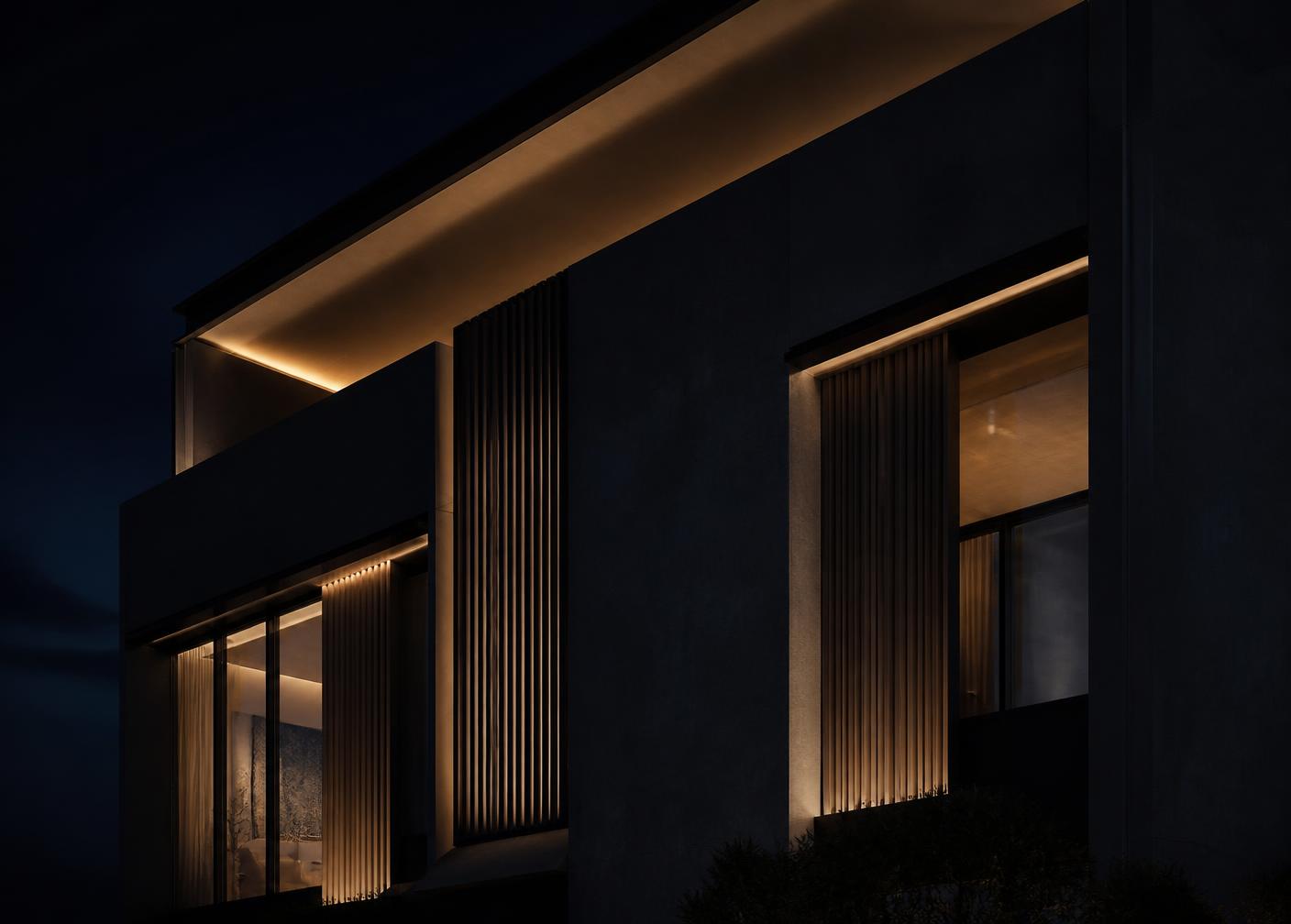 Fachada de residência de alto padrão iluminada à noite
